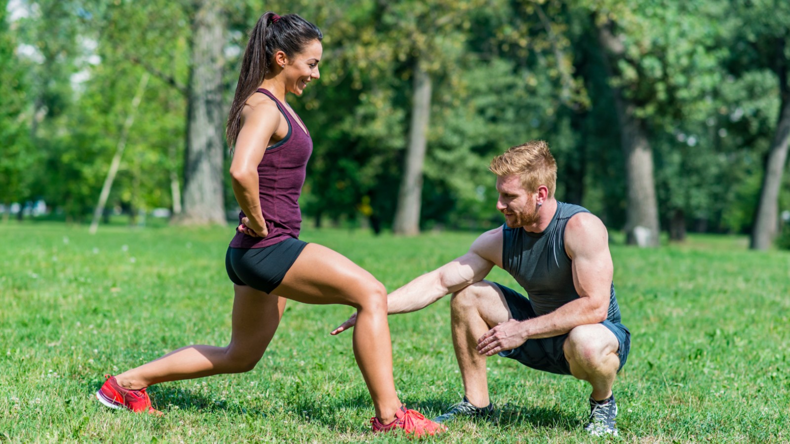 Personal trainer and client working out in a park